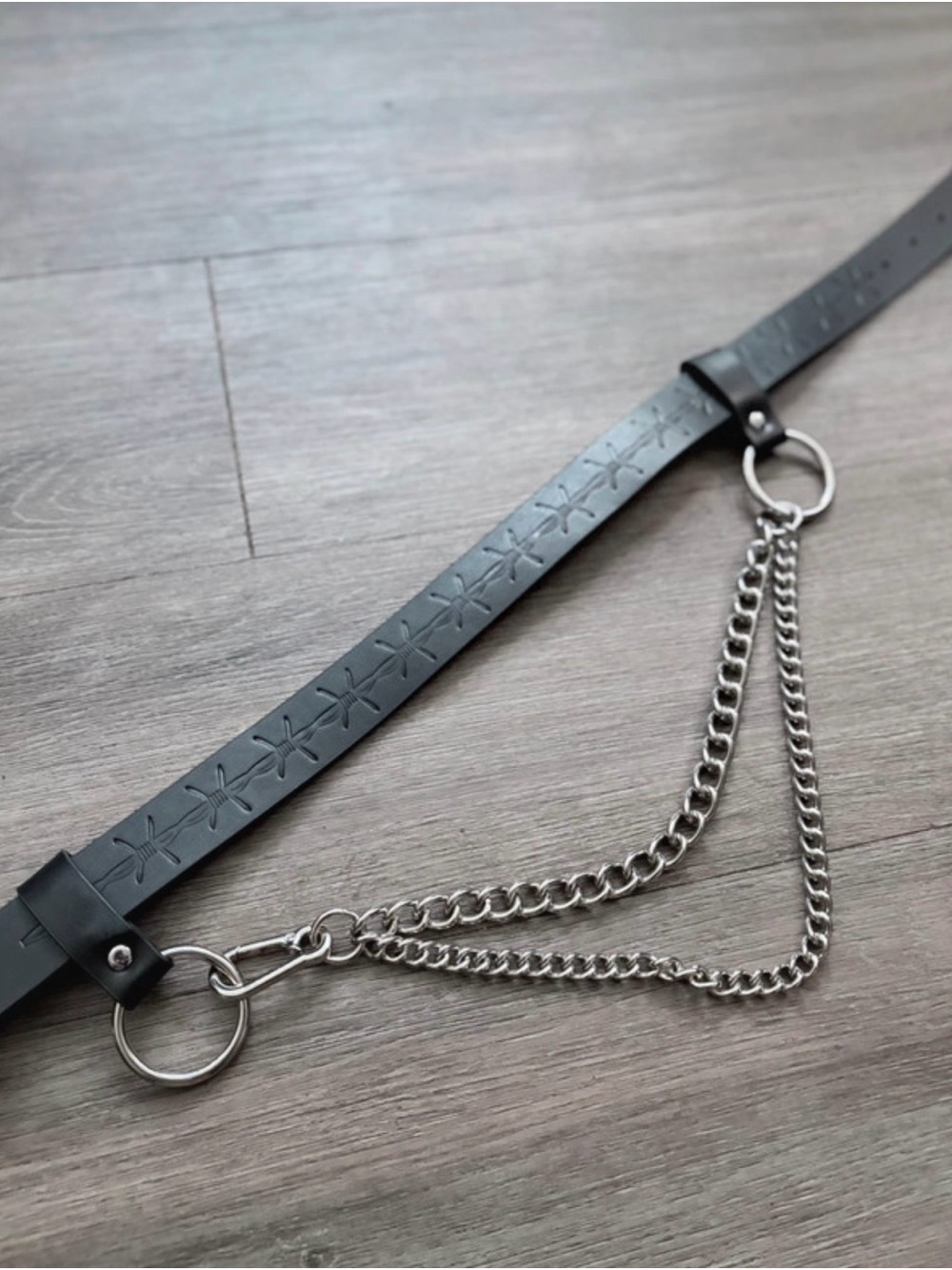 Black Star-Embossed Leather Belt with Silver Chain Accent